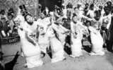 A traditional Burmese orchestra, or 'saingwaing', is composed of wind instruments, Burmese trumpets ('ne'), brass gongs ('mow') and the large barrels or drum circles also known as 'saingwaing' which are lined with hanging tambourines. Troupes are still popular today at Buddhist festivals and national events.