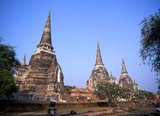 Wat Phra Si Sanphet was built around 1448 during the reign of King Borommatrailokanat, also known as Somdet Phra Ramesuan Boromma Trailokanat Bopit (1431–1488) who was the king of Ayutthaya from 1448 to 1488.<br/><br/>


Ayutthaya (Ayudhya) was a Siamese kingdom that existed from 1351 to 1767. Ayutthaya was friendly towards foreign traders, including the Chinese, Vietnamese (Annamese), Indians, Japanese and Persians, and later the Portuguese, Spanish, Dutch and French, permitting them to set up villages outside the city walls. In the sixteenth century, it was described by foreign traders as one of the biggest and wealthiest cities in the East. The court of King Narai (1656–1688) had strong links with that of King Louis XIV of France, whose ambassadors compared the city in size and wealth to Paris.